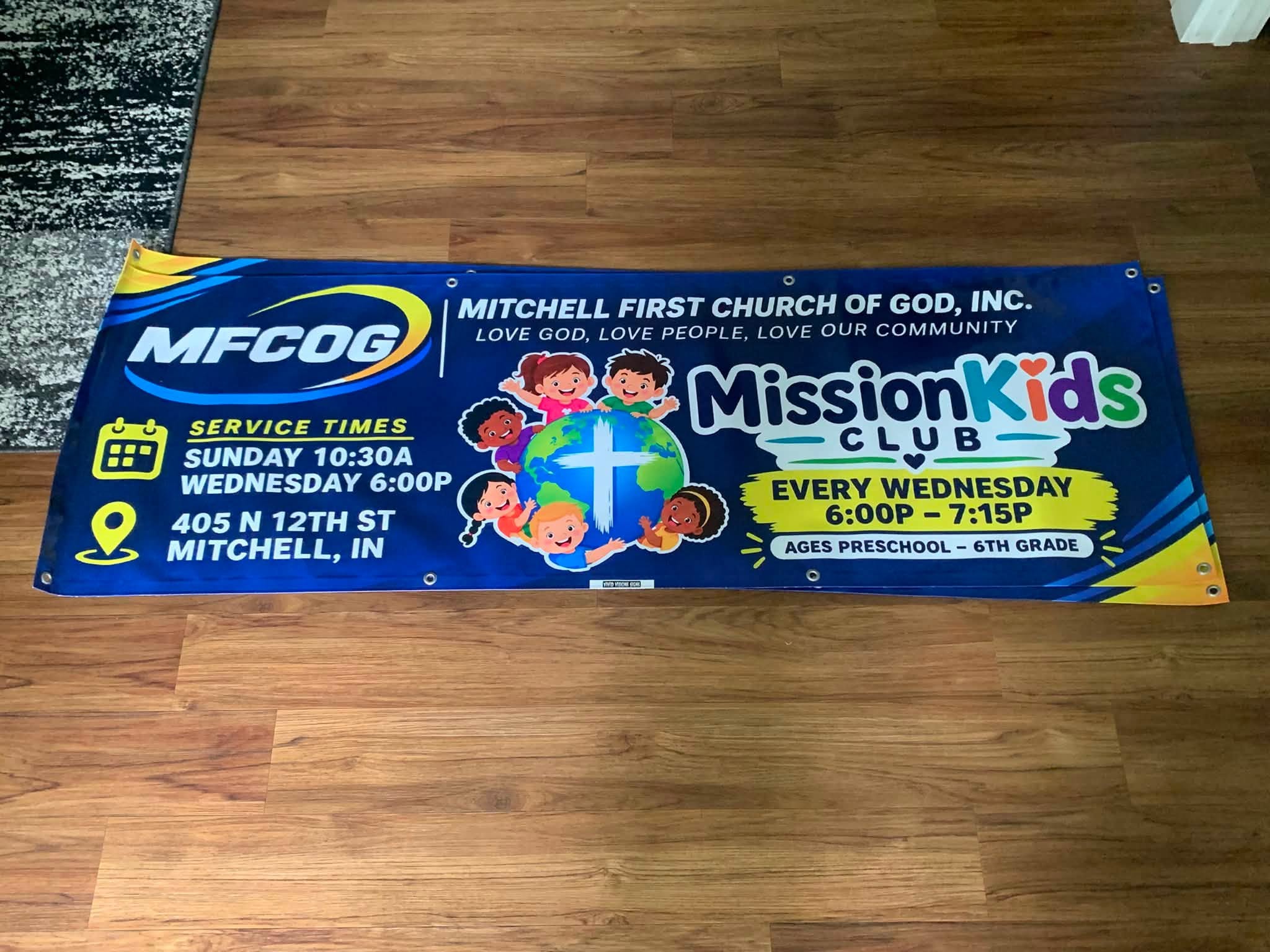 Mitchell First Church of God banner showing service times and the MissionKids Club night