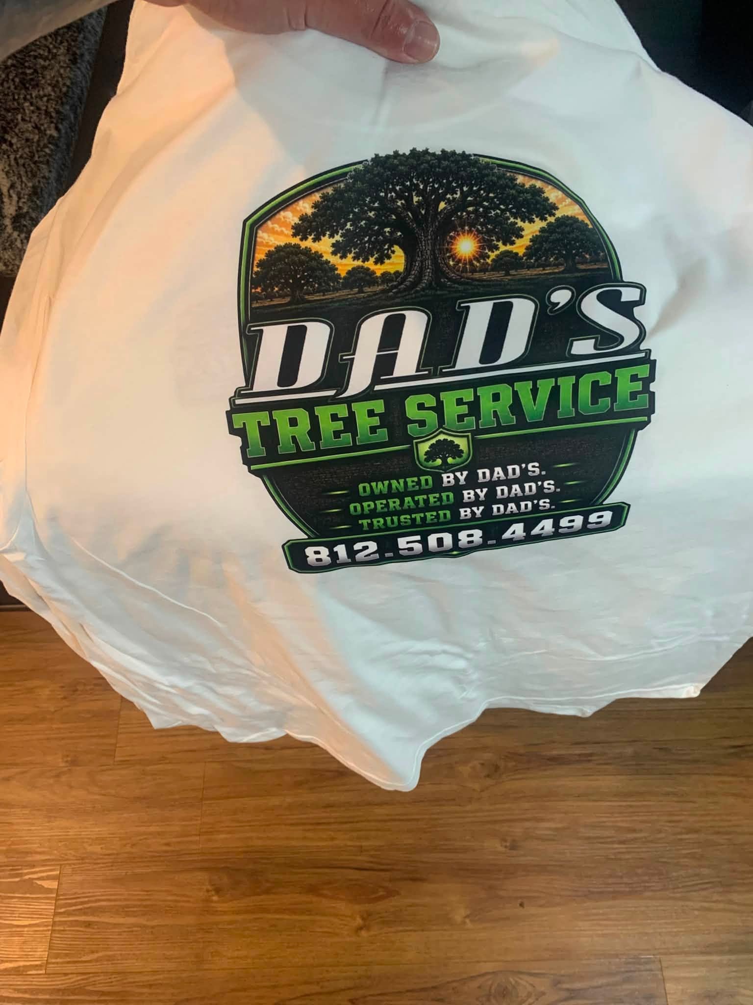 Dad's Tree Service logo printed on a white t-shirt