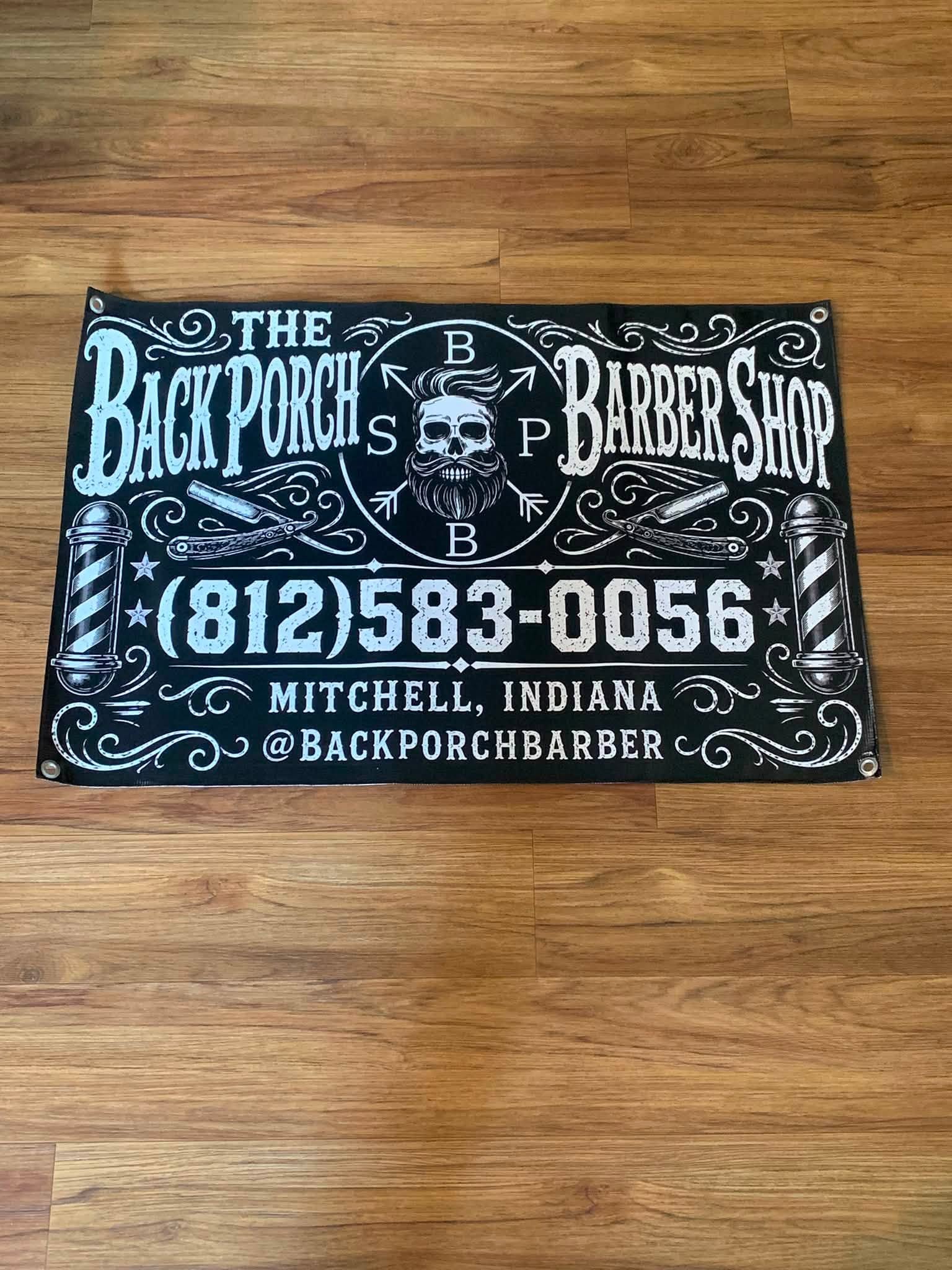 The Back Porch Barber Shop custom banner with hand-lettered styling, straight razors, and barber poles